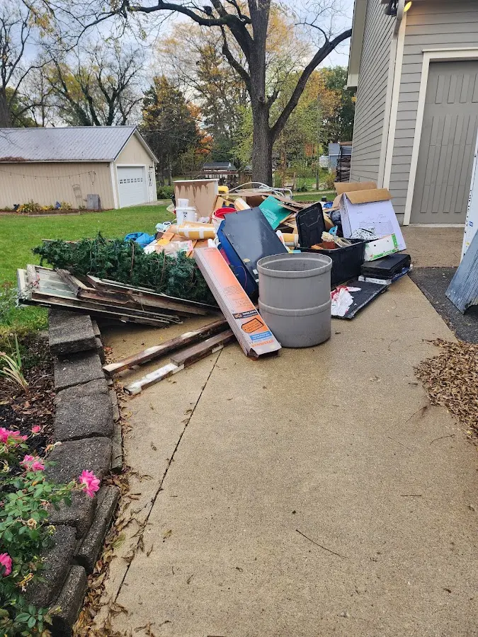 Dumpster being loaded with debris for Estate Cleanout Dumpster Rental in Oregon City